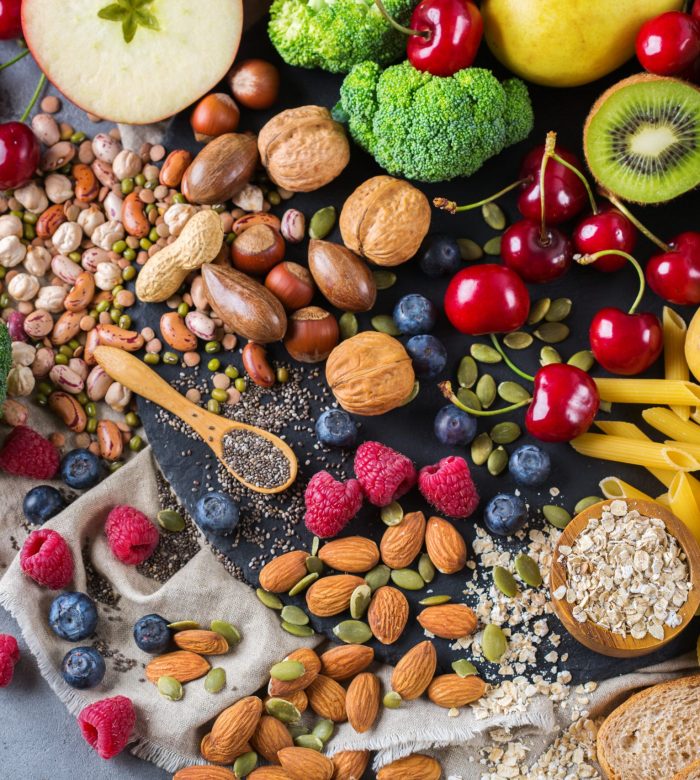 Healthy balanced dieting concept. Selection of rich fiber sources vegan food. Vegetables fruit seeds beans ingredients for cooking. Top view flat lay